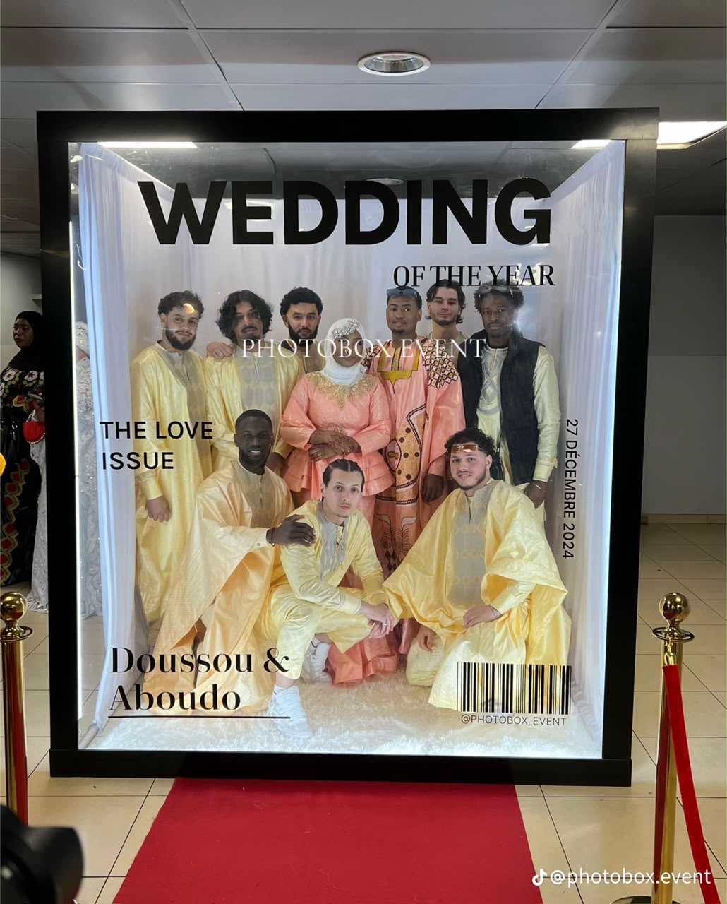 Wedding party posing inside a magazine-cover photo booth