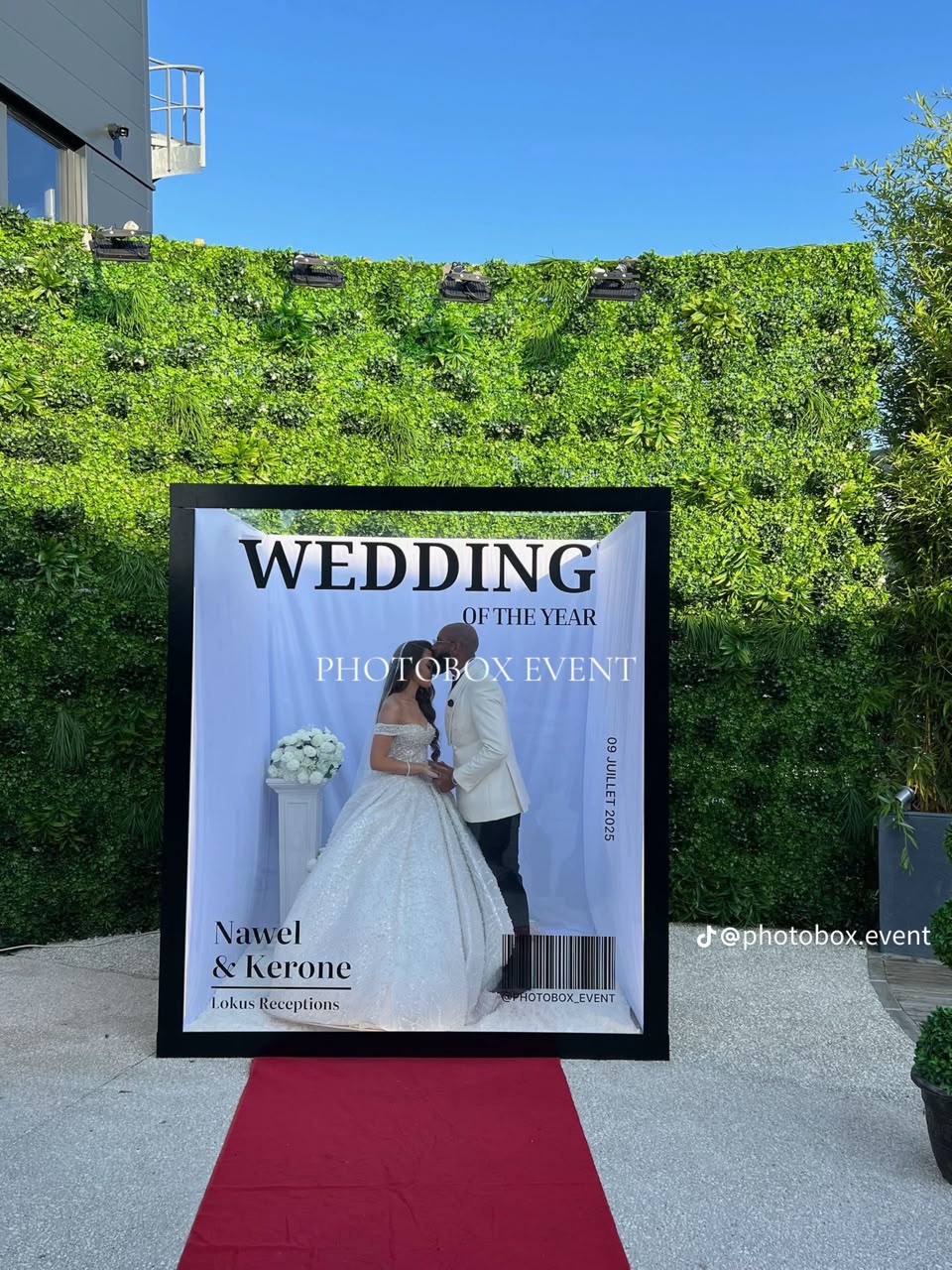 Wedding couple posing inside a magazine-cover photo booth